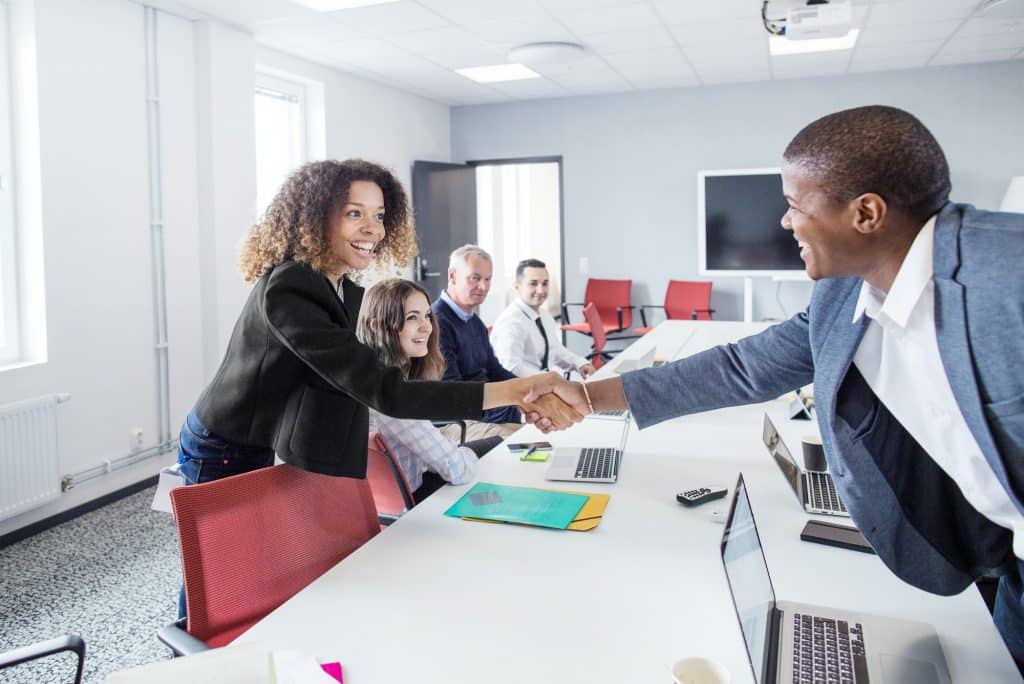 Architect greeting colleague at office meeting